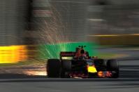 Formula One - F1 - Australian Grand Prix - Melbourne, Australia - 25/03/2017 Red Bull Racing driver Max Verstappen of the Netherlands showers sparks from his car during the third practice session. REUTERS/Jason Reed