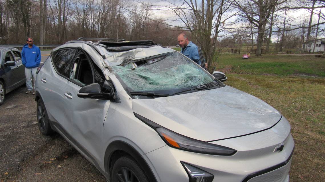 Steve Hosner, right, looks over his damaged car. High winds blew down a tree on March 3, 2023 and hit his car as he drove on U.S. 27 in Lincoln County.