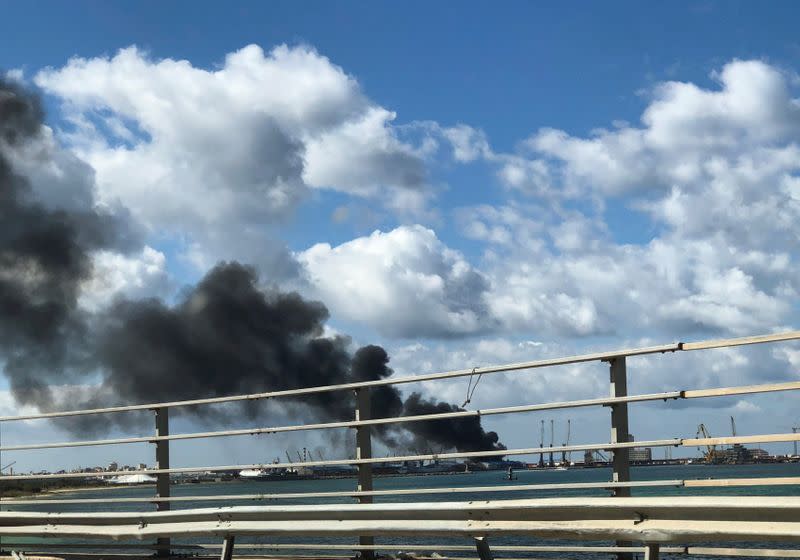 Smoke rises from a port of Tripoli after being attacked in Tripoli