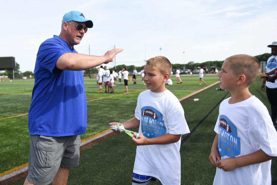 Former Okemos High School football coach Paul Palmer works with young athletes Saturday, June 25, 2022, during the Taylor Moton 517 Football Camp at the Hope Sports Complex in Lansing. Moton, a tackle for the Carolina Panthers, credits the success of his football camp to his former high school football coach.