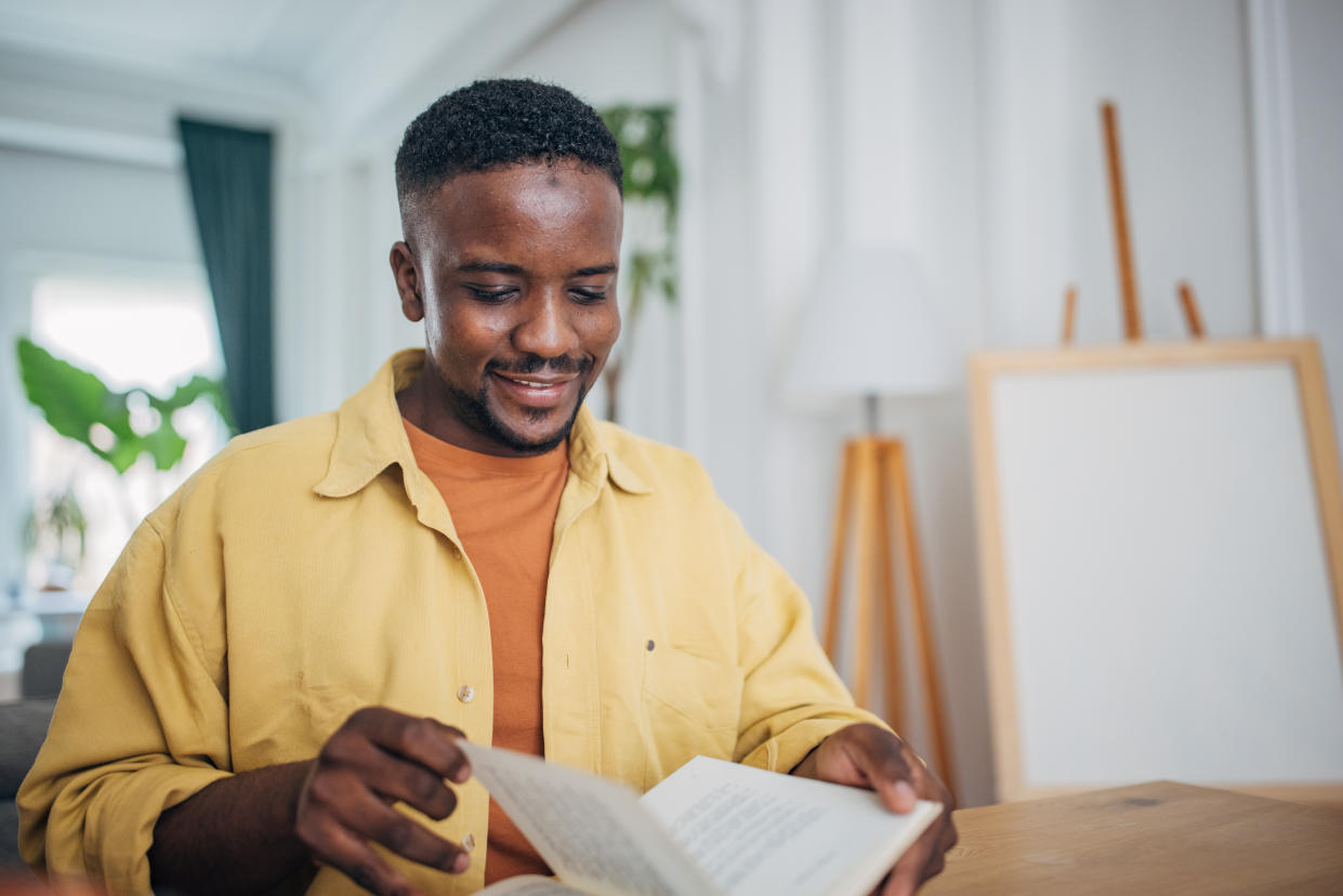 Man reading a book at home