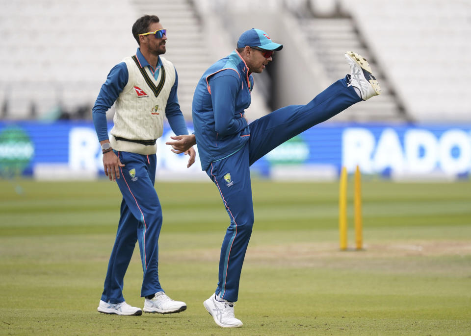 Australia's Mitchell Starc, left, and Josh Hazlewood, right, stretch during a nets session at Headingley, Leeds, England, Wednesday, July 5, 2023. (Martin Rickett/PA via AP)