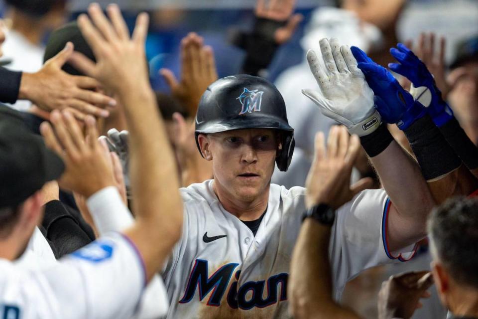 Miami Marlins base runner Garrett Cooper (26) reacts with teammates after hitting a home run during the sixth inning of an MLB game against the New York Mets at LoanDepot Park in Miami, Florida, on Thursday, March 30, 2023.