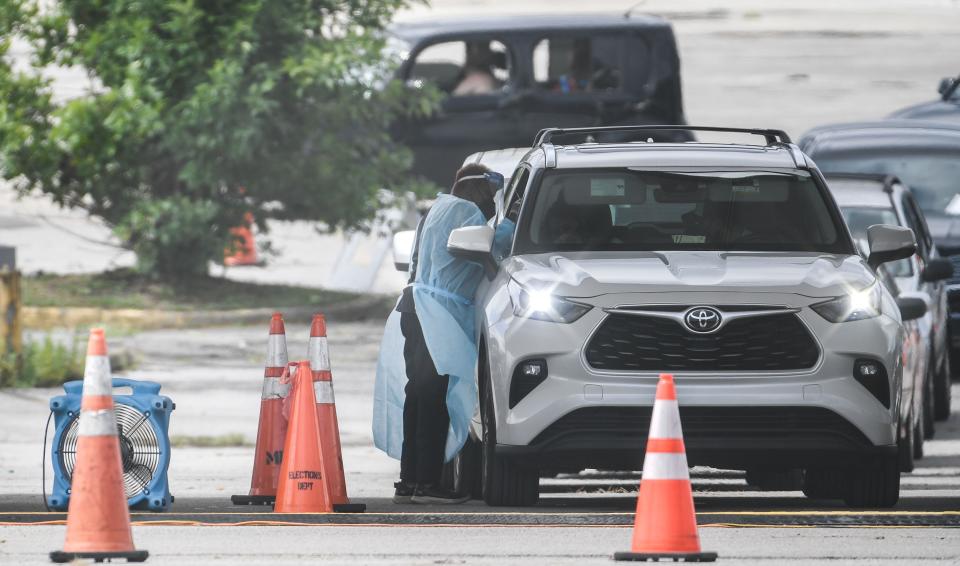 Cars line up at a COVID-19 testing and vaccination site in Nashville, Tenn., Wednesday, Sept. 1, 2021.