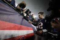 New England Patriots quarterback Tom Brady shakes hands with a fan as he leaves the field after losing an NFL wild-card playoff football game to the Tennessee Titans, Saturday, Jan. 4, 2020, in Foxborough, Mass. (AP Photo/Charles Krupa)