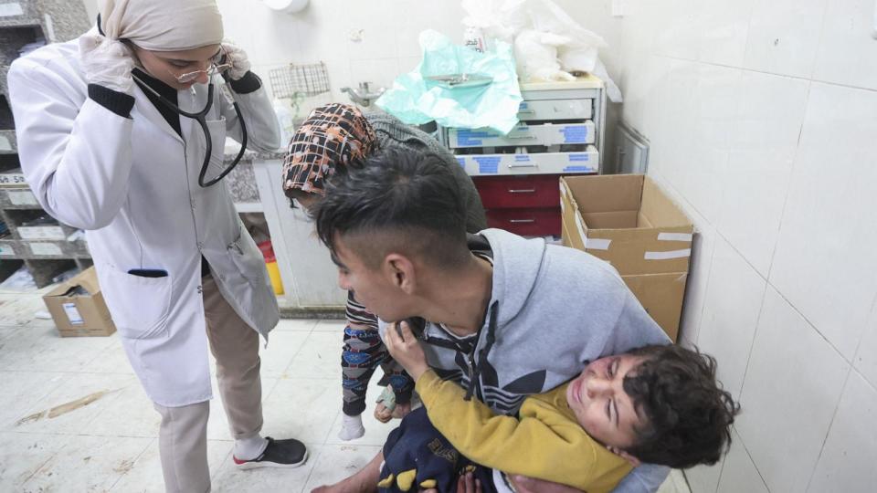 PHOTO: A Palestinian holds a child wounded in an Israeli strike at Nasser Hospital, amid the ongoing conflict between Israel and the Palestinian Islamist group Hamas, in Khan Younis in the southern Gaza Strip Jan. 22, 2024.  (Ahmed Zakot/Reuters)