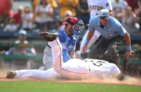 Jun 17, 2018; Pittsburgh, PA, USA; Cincinnati Reds catcher Curt Casali (38) tags Pittsburgh Pirates first baseman Josh Bell (55) out at home plate during the eighth inning at PNC Park. Mandatory Credit: Charles LeClaire-USA TODAY Sports