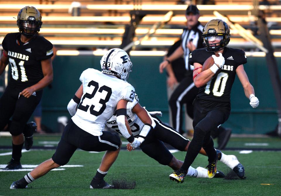 Abilene High defensive back Beckham Paul zig-zags his way through Odessa Permian players after picking off a pass during last season's game in Abilene.