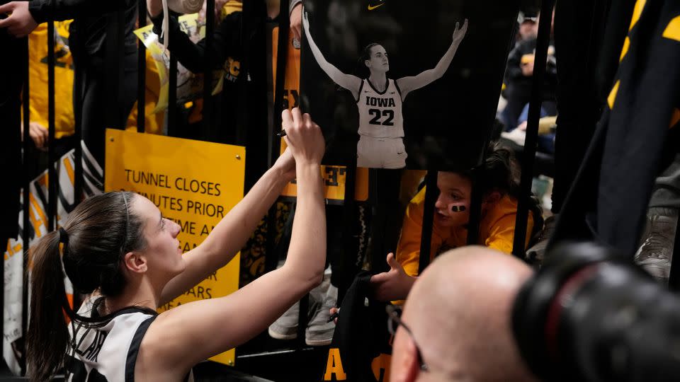 Clark signs an autograph after becoming the all-time NCAA women's college basketball top scorer. - Matthew Putney/AP