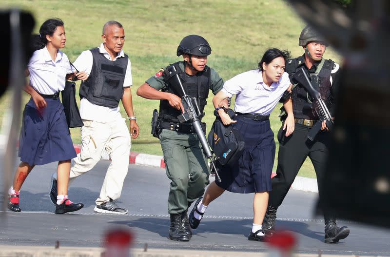 Thai security forces evacuate students stranded inside the Terminal 21 shopping mall following a gun battle to try to stop a soldier on a rampage after a mass shooting, Nakhon Ratchasima