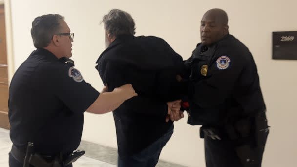 PHOTO: In this screen grab from a video, Manuel Oliver walked away in handcuffs after being arrested outside an Oversight Committee hearing at the U.S. Capitol in Washington, D.C., on March 23, 2023. (Will Steakin/ABC News)