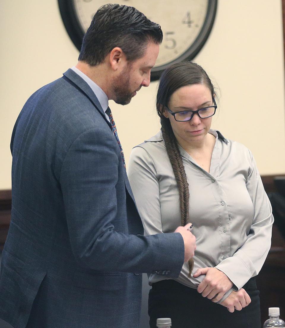 Defense attorney Jeff Laybourne talks with Erica Stefanko before the start of trial on Monday in Akron. Stefanko is accused of making the bogus pizza delivery call that lured Ashley Biggs to where she was killed.