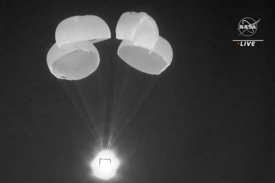 In this image made from video supplied by NASA, SpaceX Dragon capsule uses parachutes as it descends in the Gulf of Mexico early Friday, May 6, 2022. NASA’s Raja Chari, Tom Marshburn and Kayla Barron, and the European Space Agency’s Matthias Maurer undocked from the International Space Station less than 24 hours earlier. (NASA via AP)