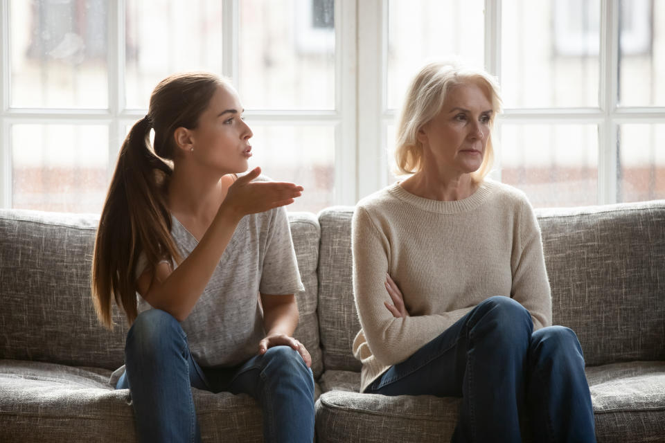 Annoyed grown up daughter expressing complaints to elderly mother annoyed females sit on couch, old stubborn mom dont want make concessions, different ages, generational gap, family conflict concept