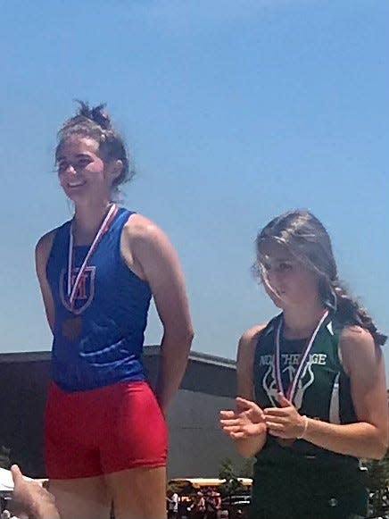 Highland's Juliette Laracuente stands on the podium after competing in the girls 100-meter hurdles at this year's Division II state track and field championships. Laracuente went on to earn a national championship in the triple jump last weekend.