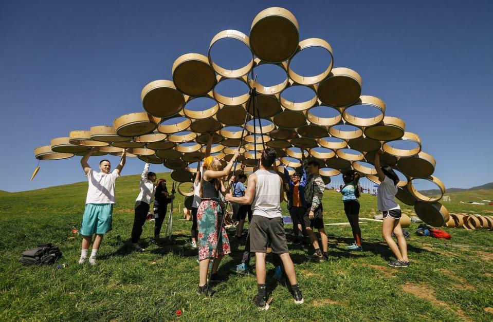 Cal Poly architecture students work to raise their dome structure made from recycled cylinders during the Cal Poly Design Village Competition in Poly Canyon.