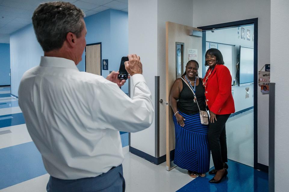Superintendent Mike Burke snaps a photo of school board member Marcia Andrews (right) in August. While phones are not banned in Palm Beach County schools, most social media websites where students would post and share photos are not accessible on district devices or wifi.