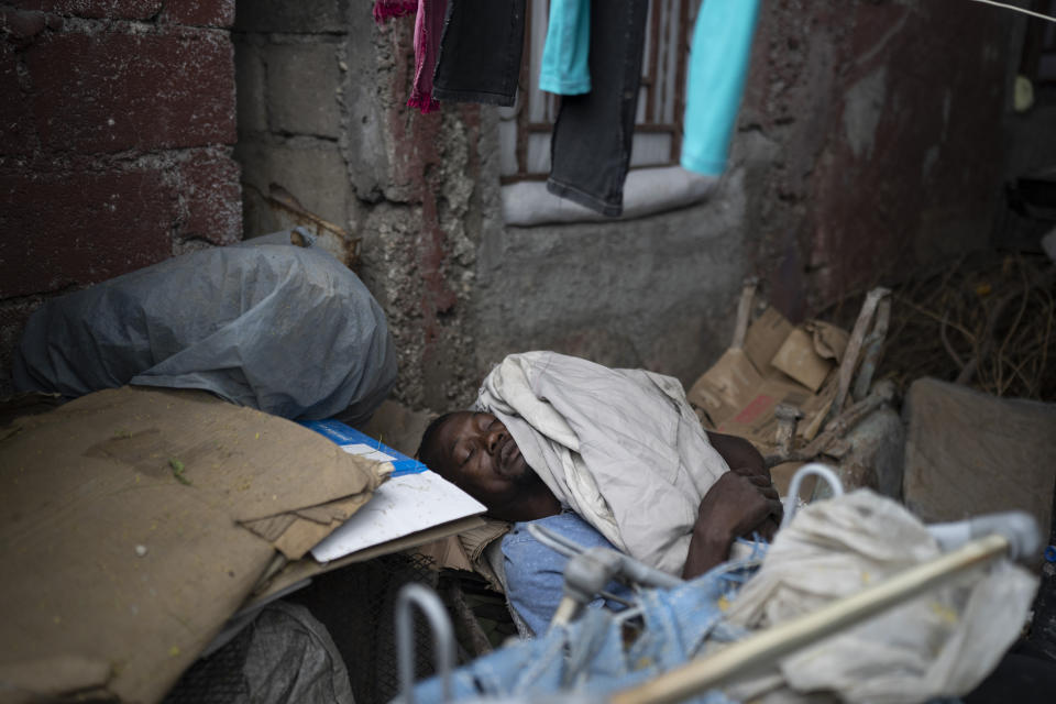A man displaced by gang violence sleeps in Jean-Kere Almicar's front yard, in Port-au-Prince, Haiti, Friday, June 2, 2023. Nearly 200 people who once lived in the Cite Soleil slum near Almicar’s house are now camped out in his front yard and nearby areas. They are among the nearly 165,000 Haitians who have fled their homes amid a surge in gang violence. (AP Photo/Ariana Cubillos)
