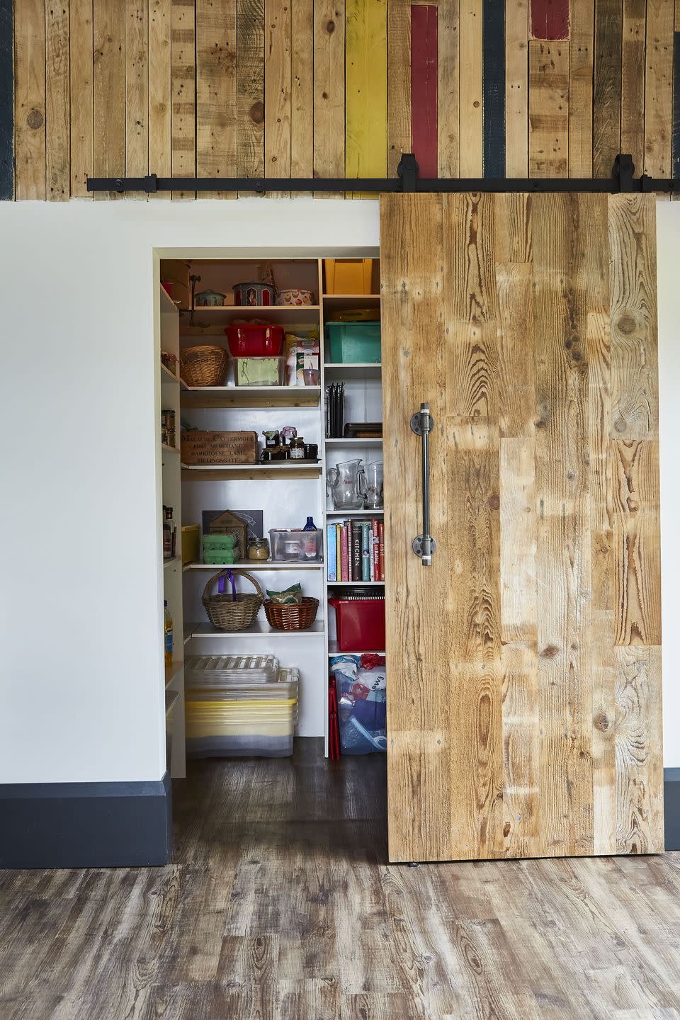 <p>Set the scene in your kitchen with this dramatic, rustic style. Here, the sliding door zones the space, while the pops of colour on the wooden panels above add plenty of charm. </p><p>• Discover more from <a href="https://maincompany.com/" rel="nofollow noopener" target="_blank" data-ylk="slk:The Main Company;elm:context_link;itc:0;sec:content-canvas" class="link ">The Main Company</a></p>