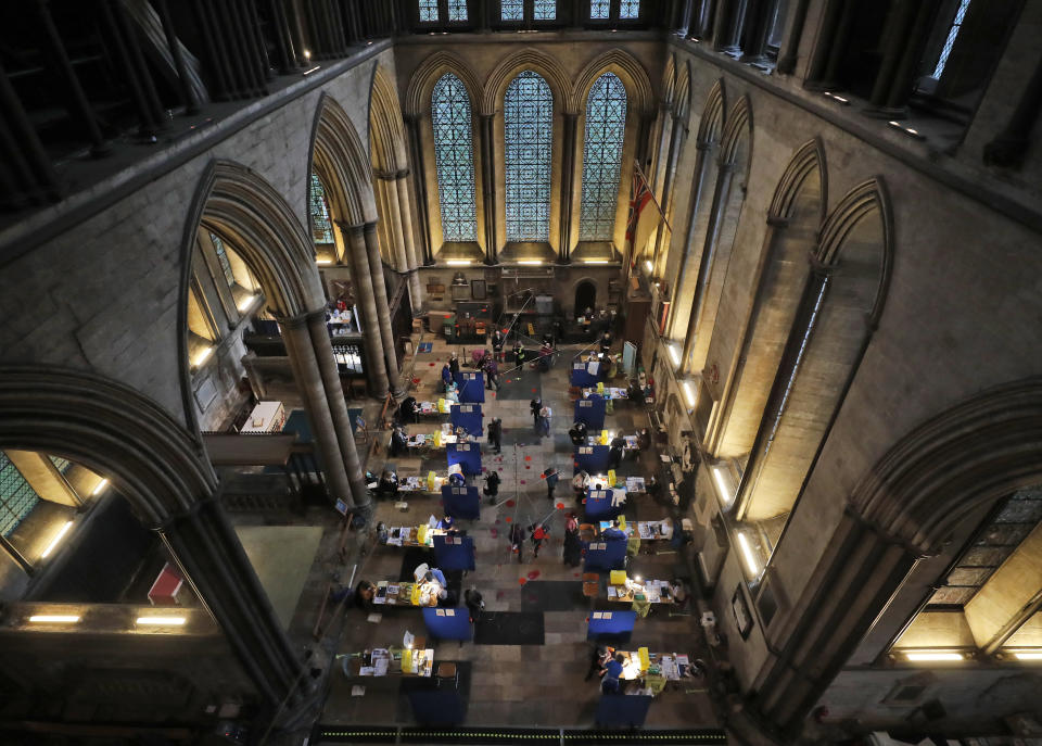 FILE - In this Wednesday, Jan. 20, 2021 file photo, tables are set up to provide people with the Pfizer-BioNTech vaccine inside Salisbury Cathedral in Salisbury, England. So far in the vaccine race UK vaccination stats have a rate of 15 percent compared to some 3 percent in the EU bloc. The EU has already lost some 480,000 citizens to the pandemic in a bloc of 450 million with more fatalities mounting by the day. (AP Photo/Frank Augstein, File)