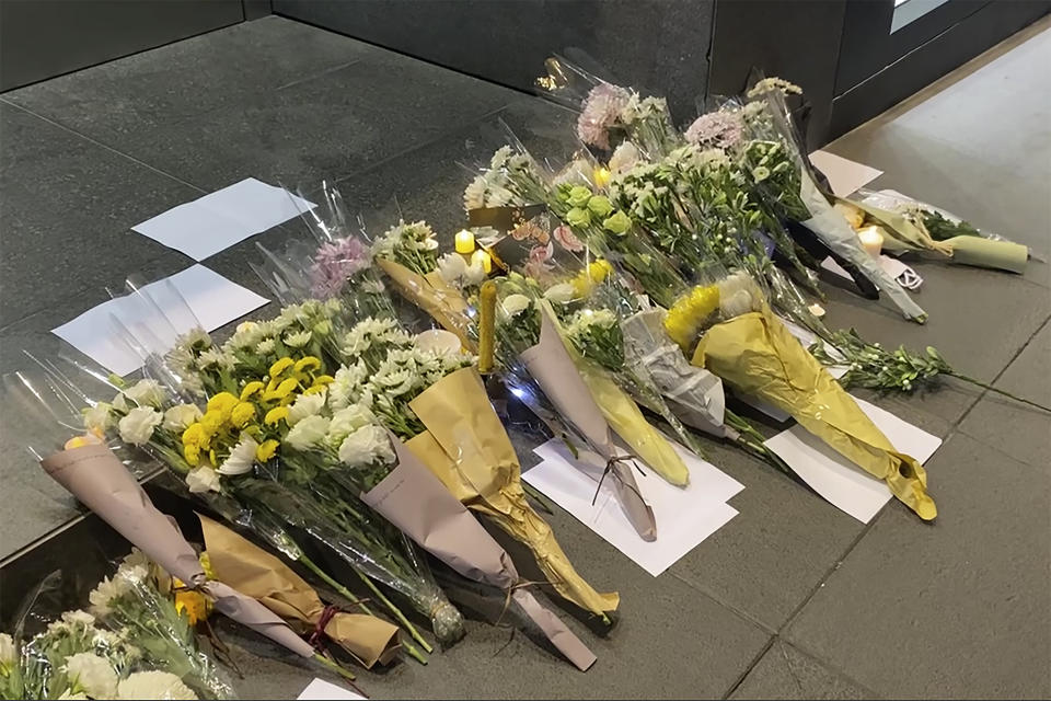 Blank white papers and flowers are laid down during a commemoration for victims of a recent Urumqi deadly fire in Central in Hong Kong, Monday, Nov. 28, 2022. Students in Hong Kong chanted “oppose dictatorship” in a protest against China’s anti-virus controls after crowds in mainland cities called for President Xi Jinping to resign in the biggest show of opposition to the ruling Communist Party in decades. (AP Photo/Zen Soo)