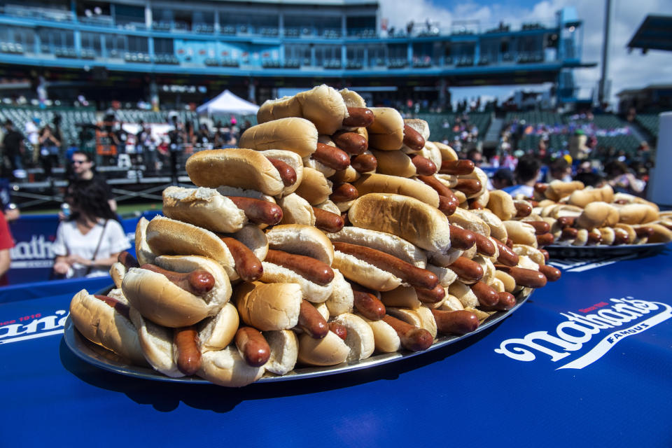 Hot dogs are stacked on platters before the world's best eating athletes go head-to-head in the 10-minute, all-you-can-eat contest at the Nathan's Famous Fourth of July International Hot Dog-Eating Contest in Coney Island's Maimonides Park on Sunday, July 4, 2021, in New York. (AP Photo/Brittainy Newman)