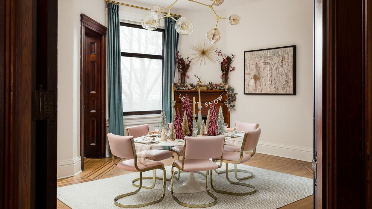 a dining room with a chandelier and chairs