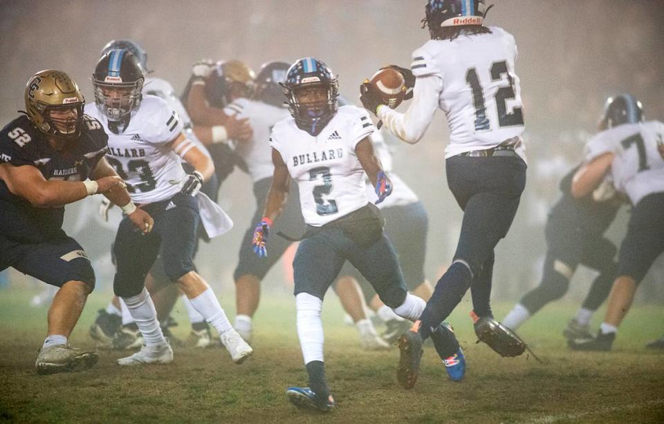 Bullard’s Jalyn Utendahl pitches the ball to teammate Daizon Allen (12) during the CIF Division II Northern California Regional Championship game with Central Catholic at Central Catholic High School in Modesto, Calif., Dec. 3, 2021. Central Catholic won the game 44-41.