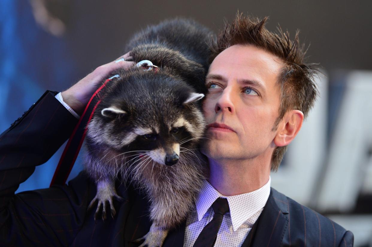 US director James Gunn (R) and a racoon attend the European premiere of the film, Guardians of the Galaxy in central London on July 24, 2014. AFP PHOTO / CARL COURT        (Photo credit should read CARL COURT/AFP/Getty Images)