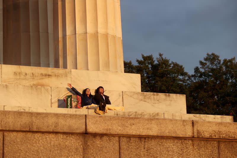 A young couple pray at Easter sunrise at the Lincoln Memorial during the coronavirus disease (COVID-19) outbreak in Washington