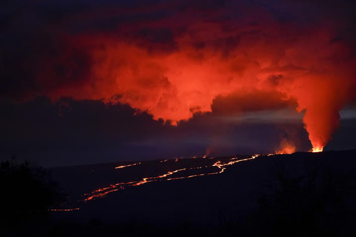 Lava erupts from Hawaii's Mauna Loa volcano Nov. 30, 2022, near Hilo, Hawaii. Mauna Loa’s volcano eruption has temporarily knocked off power to the world’s premier station that measures heat-trapping carbon dioxide in the atmosphere, but officials said that there are hundreds of other carbon dioxide monitoring sites across the globe. (AP Photo/Gregory Bull)