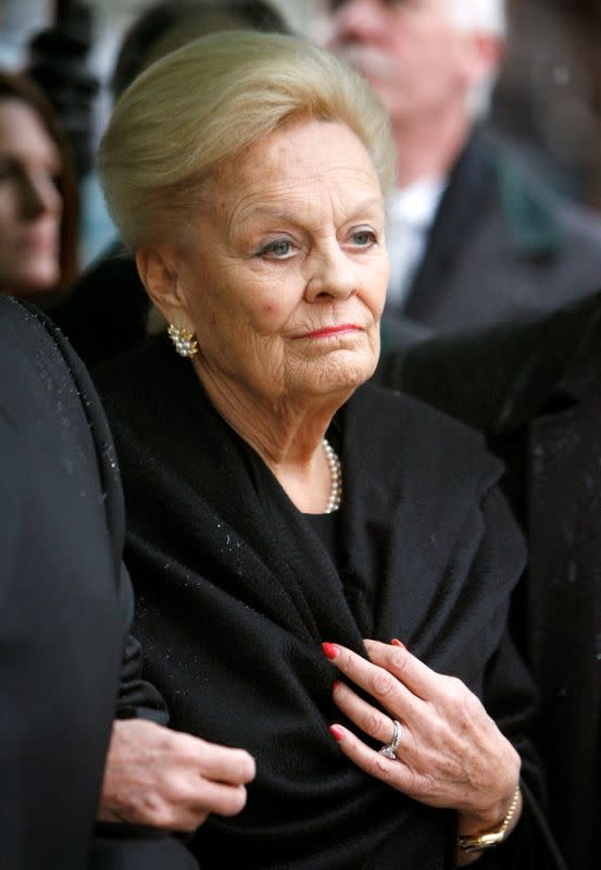 FILE PHOTO: Loretta Rogers watches as the casket of her late husband Ted Rogers, president and CEO of Rogers Communications, arrives for funeral services in Toronto