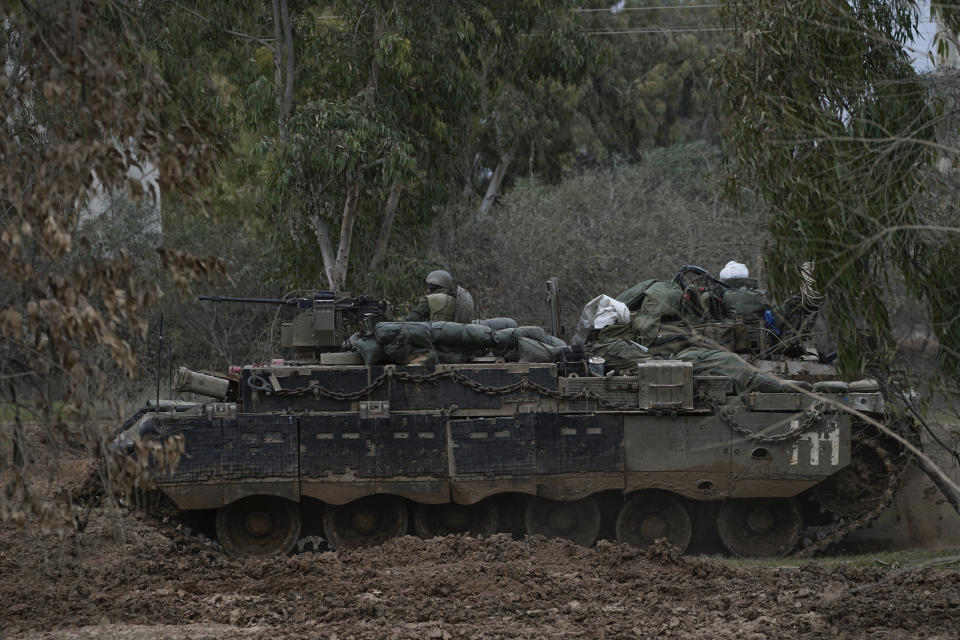 Israeli troops are seen near the Gaza Strip border, in southern Israel, Thursday, Dec. 21, 2023. The army is battling Palestinian militants across Gaza in the war ignited by Hamas' Oct. 7 attack into Israel. (AP Photo/Ohad Zwigenberg)