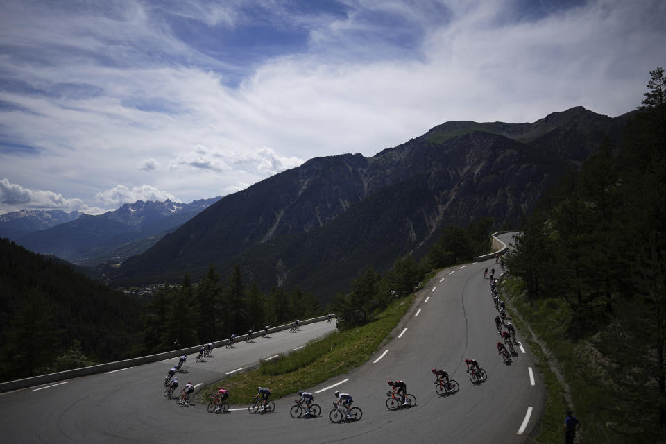 The pack rides during the fourth stage of the Tour de France cycling race over 139.6 kilometers (86.7 miles) with start in Pinerolo, Italy and finish in Valloire, France, Tuesday, July 2, 2024. (AP Photo/Daniel Cole)