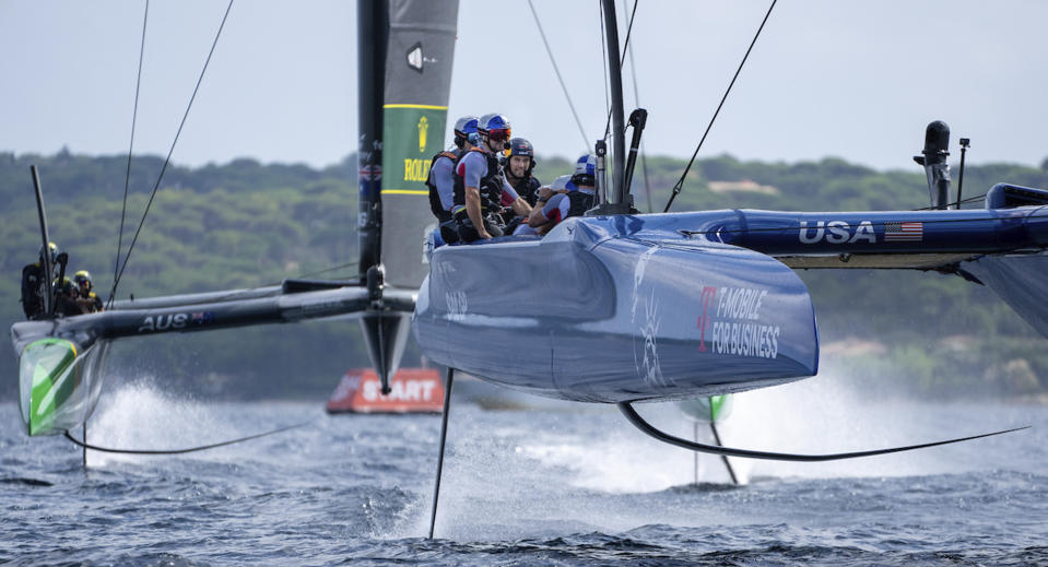 In this photo provided by SailGP, Sergio Perez, Red Bull Racing Formula One driver, sits behind Jimmy Spithill, CEO & driver of USA SailGP Team, as the USA SailGP Team take part in a 'drag race' against Australia SailGP Team ahead of the France Sail Grand Prix in St. Tropez, France, on Sept. 6, 2022. Two of the world's best skippers are trying to reclaim their sea legs before falling further behind in SailGP's race for the $1 million Season 3 championship. (Adam Warner/SailGP via AP)