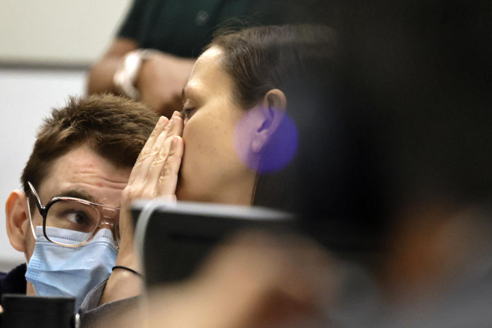 Nikolas Cruz speaks with sentence mitigation specialist Kate O'Shea in court during the penalty phase of his trial at the Broward County Courthouse in Fort Lauderdale on Thursday, July 21, 2022. Cruz previously plead guilty to all 17 counts of premeditated murder and 17 counts of attempted murder in the 2018 shootings. (Mike Stocker/South Florida Sun Sentinel via AP, Pool)