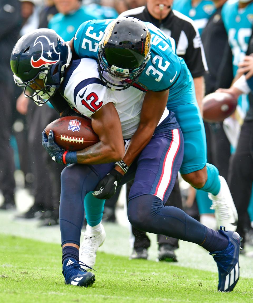 Jaguars cornerback Tyson Campbell (32) makes a tackle on Texans wide receiver Nico Collins (12) during first half action on Dec. 19.