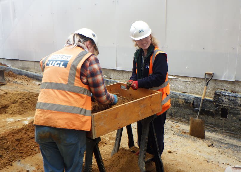 Archaeologists sieve artefacts from soil at the excavation site.