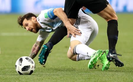 Soccer Football - World Cup - Group D - Argentina vs Croatia - Nizhny Novgorod Stadium, Nizhny Novgorod, Russia - June 21, 2018 Argentina's Lionel Messi goes down under the challenge of Croatia's Ivan Strinic REUTERS/Lucy Nicholson