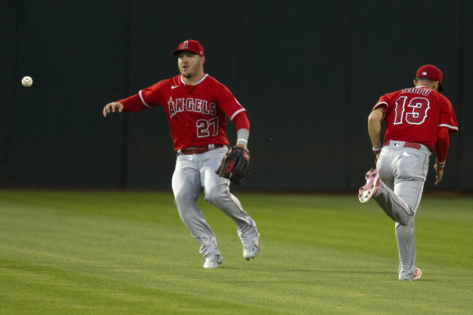 Neither Los Angeles Angels center fielder Mike Trout (27) nnor shortstop Livan Soto (13) can catch a bloop single by Oakland Athletics' Nick Allen during the first inning of a baseball game, Monday, Oct. 3, 2022, in Oakland, Calif. (AP Photo/D. Ross Cameron)