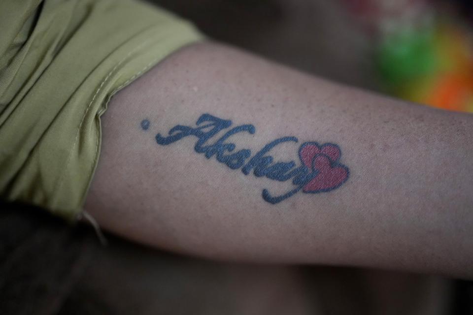 Preethi, a 38-year-old transgender woman who uses only her first name, displays a tattoo which reads the name of her former partner at her home in Bengaluru, India, Monday, July 10, 2023. (AP Photo/Aijaz Rahi)