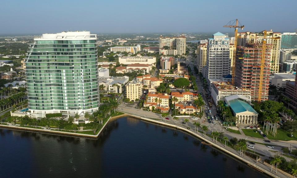 Palm Beach Atlantic University, center, is nestled between The Bristol condos, left, and One Flagler under construction in downtown West Palm Beach, Florida on July 21, 2023.