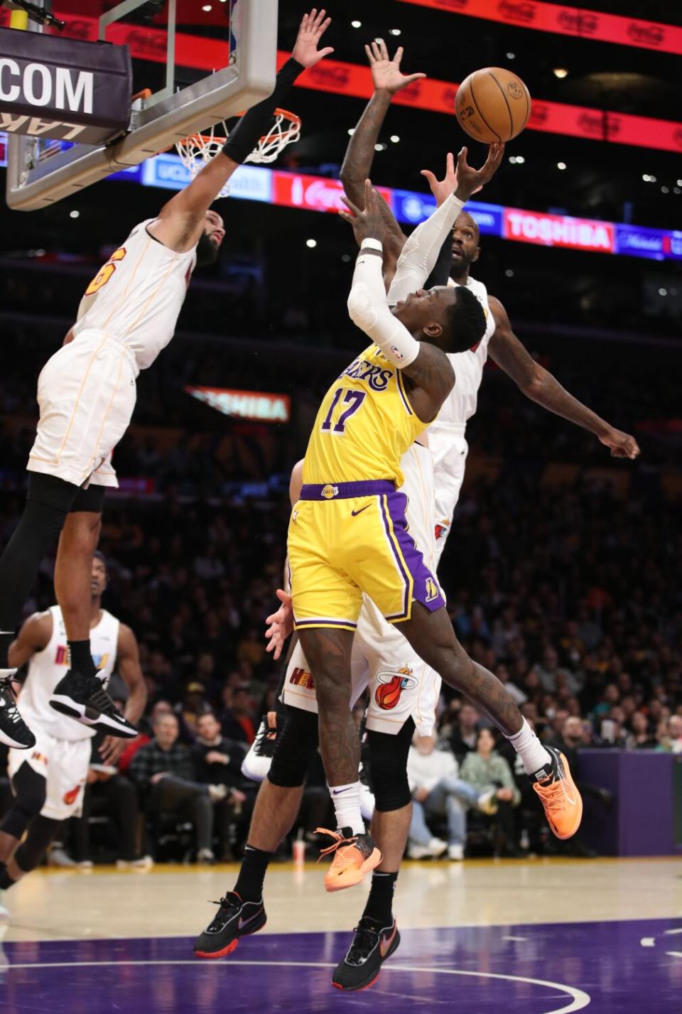 Dennis Schroder shoots while defended by Miami's Caleb Martin, left, and others Jan. 4 at Crypto.com Arena.