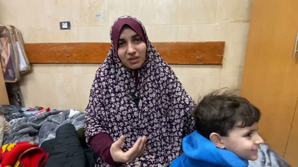 Speaking from Al-Aqsa Martyrs Hospital in Deir Al-Balah, Israa Hassan Ahmed al-Ashkar told CNN that her family had been trapped in a building in Gaza City for a week, while Israeli forces besieged the area. - Mohammad Al Sawalhi/CNN