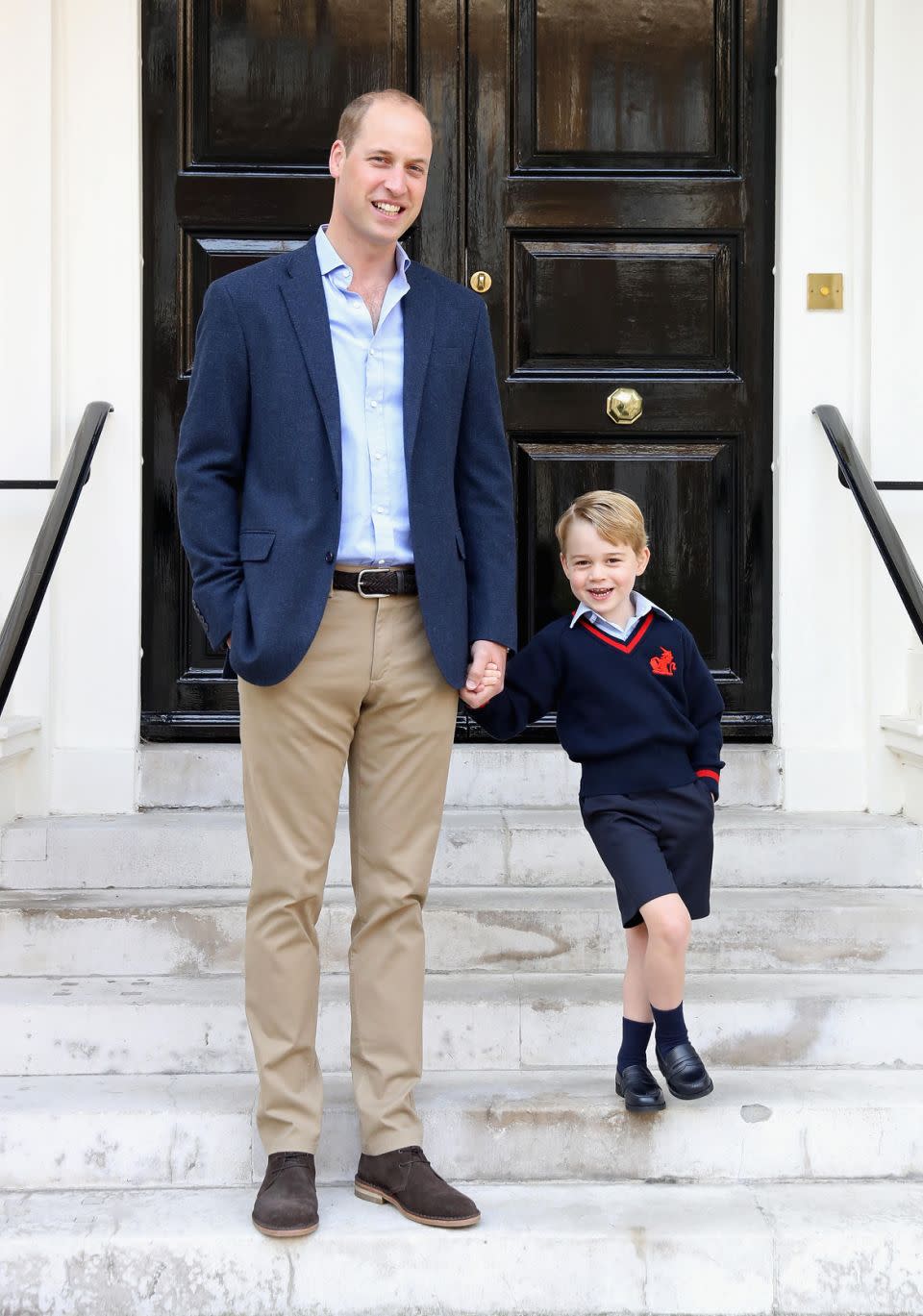 Prince George looked very happy with his dad Prince William after he finished his first day at school. Source: Getty