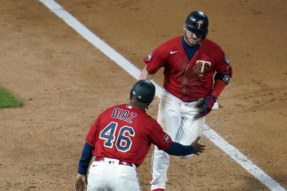 Minnesota Twins' Josh Donaldson, right, is congratulated by third base coach Tony Diaz on his two-run home run off Chicago White Sox pitcher Dallas Keuchel in the sixth inning of a baseball game, Monday, May 17, 2021, in Minneapolis. (AP Photo/Jim Mone)