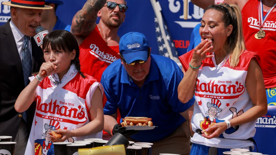 Mayoi Ebihara and Miki Sudo compete in the Nathan's hot dog eating contest on Tuesday. - Amr Alfiky/Reuters