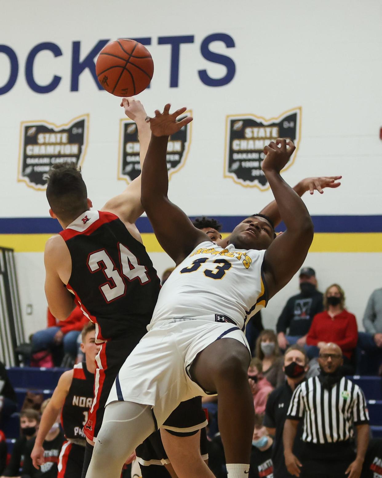 Streetsboro senior Michael Hall Jr. collides with Norton senior Phillip Wallace fighting for a rebound during Saturday's game.