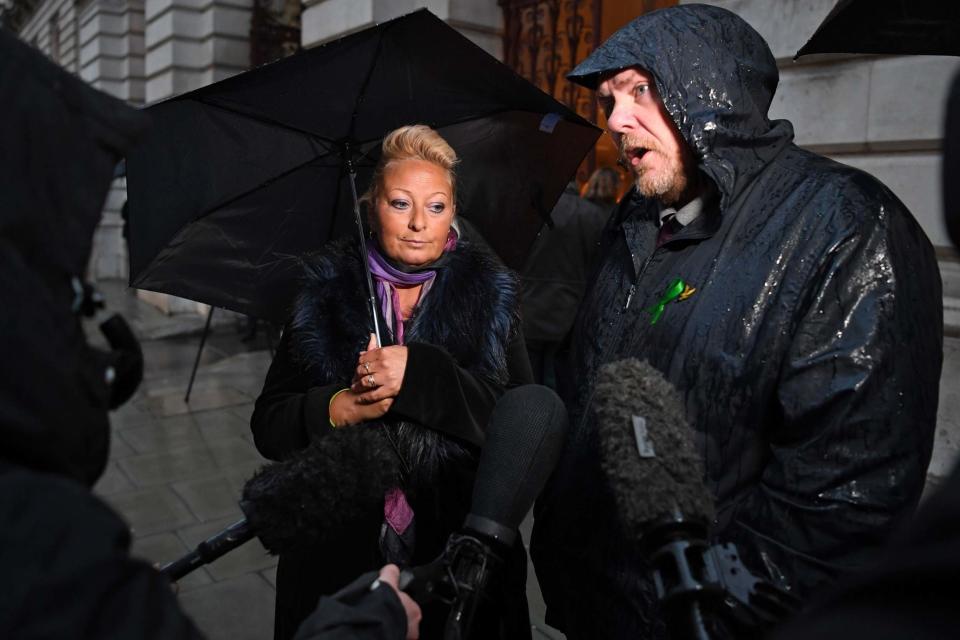 Charlotte Charles stands beside her husband Bruce Charles before a meeting with Dominic Raab (AFP via Getty Images)