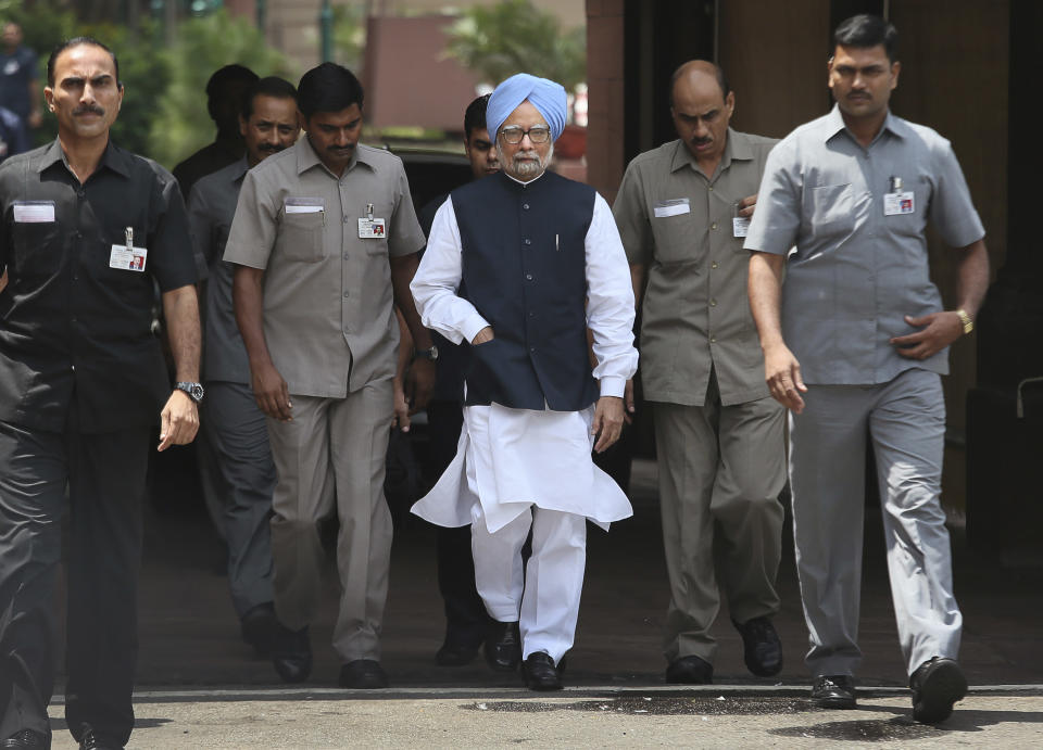 Indian Prime Minister Manmohan Singh, center, arrives to make a statement to the media after he was shouted down by opposition politicians in the lower house of Parliament, in New Delhi, India, Monday, Aug. 27, 2012. Singh took to Twitter on Monday to defend himself against a coal scandal roiling the country, saying accusations his government lost the country huge amounts of money were baseless. India's Parliament has been all but paralyzed since the national auditor released a report two weeks ago saying the sale of coal blocks without competitive bidding was expected to net private companies windfall profits of up to $34 billion. (AP Photo/Manish Swarup)